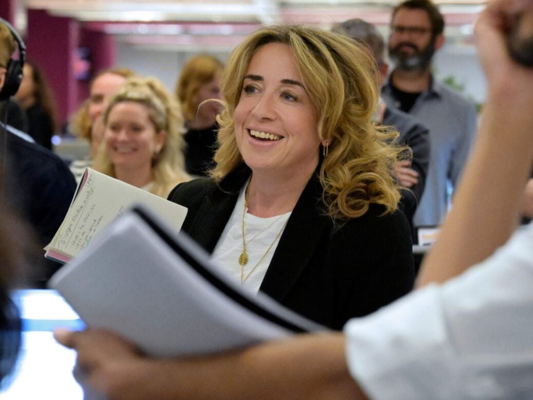 Guardian editor-in-chief Katharine Viner in the middle of the newsroom surrounded by people. They are all smiling or laughing at something out of shot