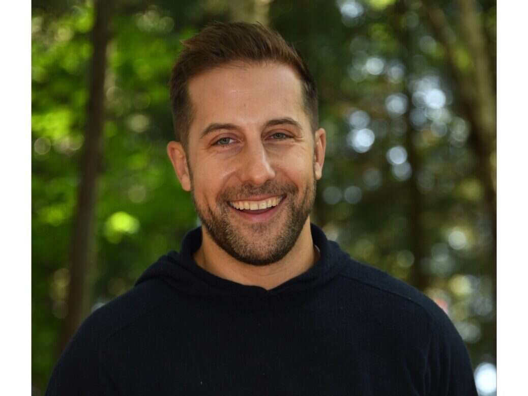 Mike Rothman headshot in front of trees.