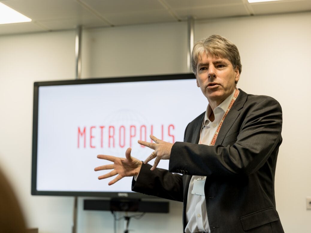 Robert Marr in front of a TV screen with the words 'Metropolis' displayed.
