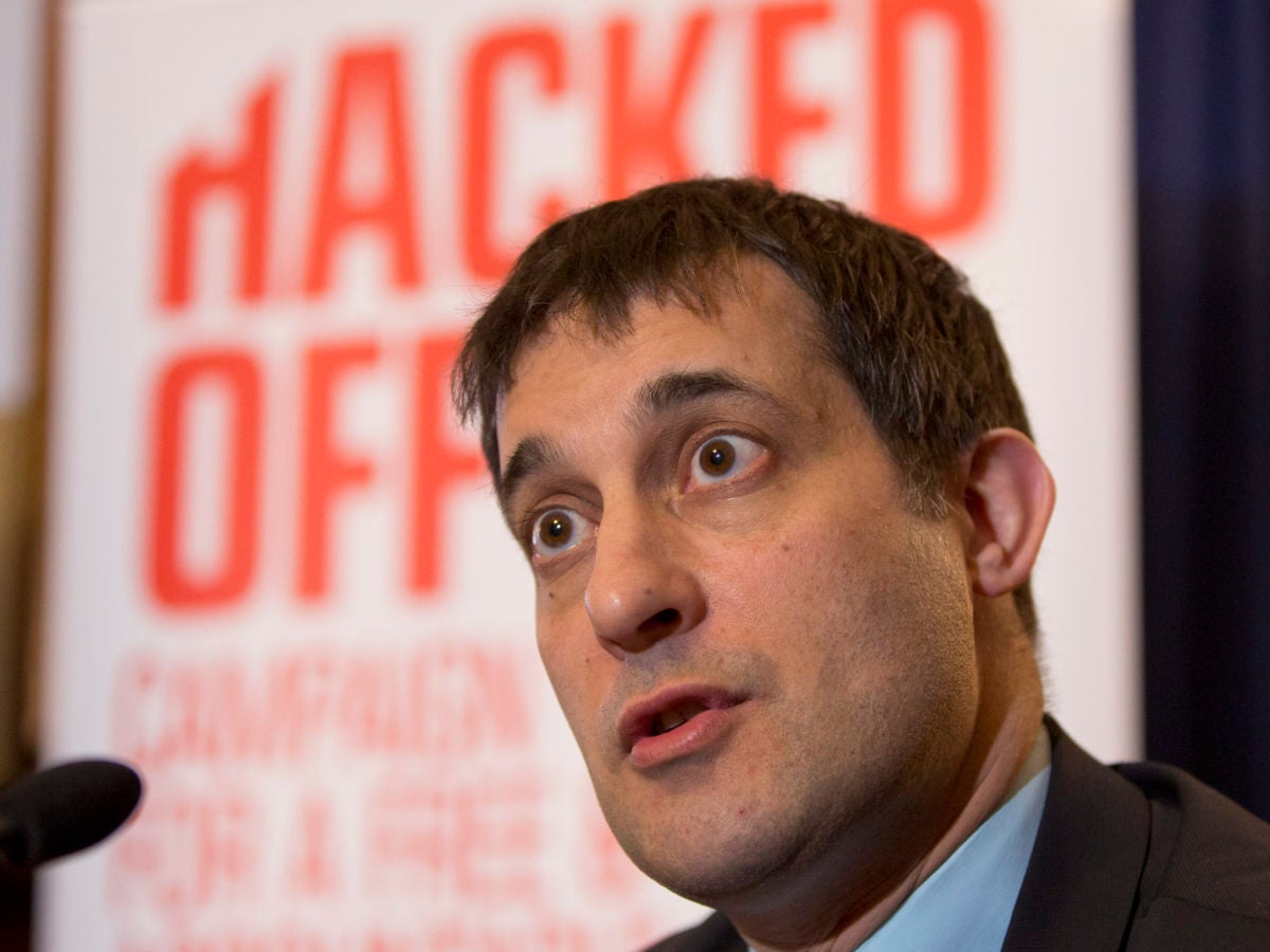 Associate director of Hacked Off, Evan Harris, pictured speaking with a Hacked Off poster behind him