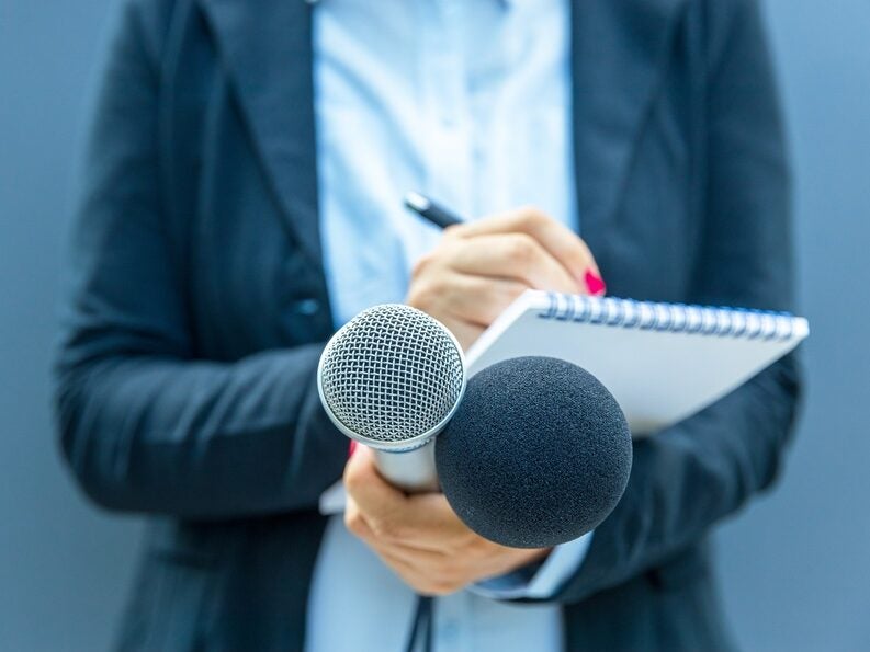 Reporter holding pad and microphone. Picture: Shutterstock/wellphoto
