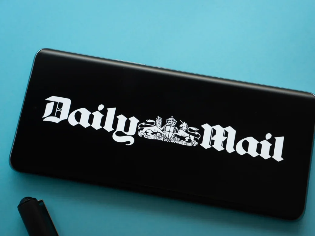 The logo of the Daily Mail is displayed on a smartphone screen, illustrating a story about parent company DMGT striking a deal to license its IP for film, TV and streaming.