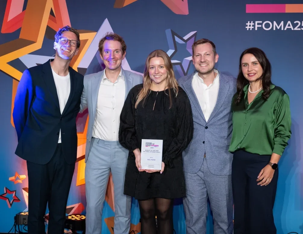 Representatives from The i Paper pick up the Website of the Year (National/International) award at the Future of Media Awards 2025, alongside host Robin Morgan and PushPushGo CEO Renata Okrajni