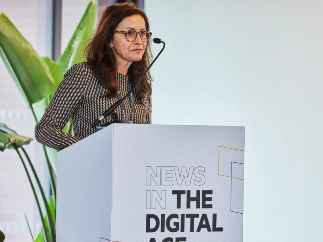 Google's Sulina Connal speaking at a lectern with News in the Digital Age event branding on it