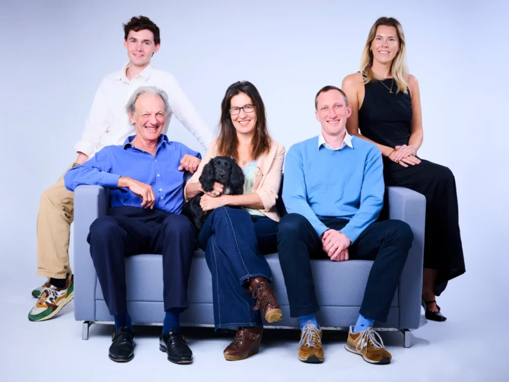 The Knowledge team from left to right: Charlie Lyons, Jon Connell, Michele Lavery, Harry Byford, Imogen Williams sitting on and around a blue sofa