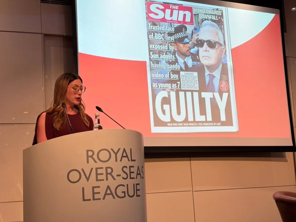Sun editor-in-chief Victoria Newton giving the Hugh Cudlipp Lecture in London on 10 September 2026 with Huw Edwards 'GUILTY' front page on screen behind her
